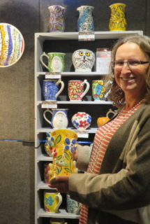 Rikki Taylor with a display of whimsical mugs